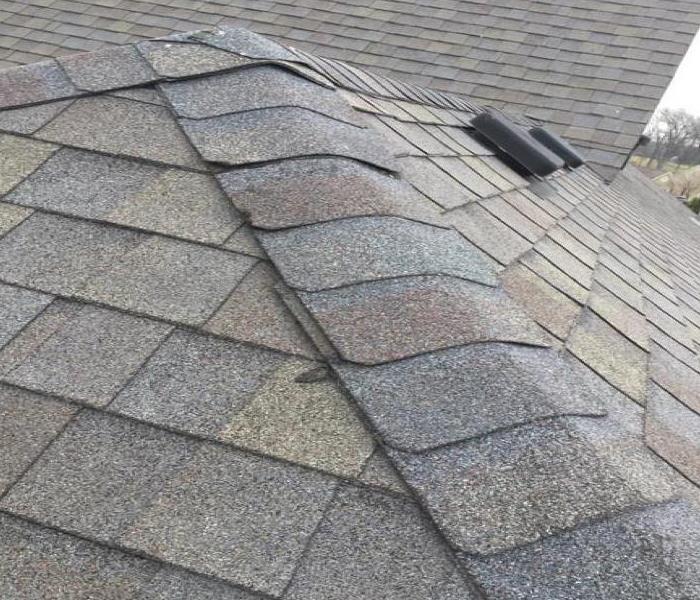 gray shingles replaced on roof after storm damage