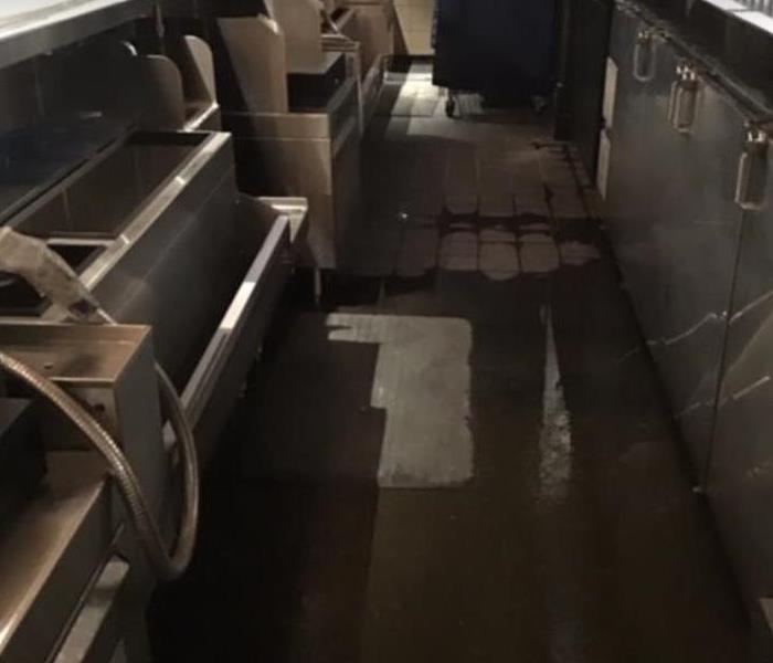 water on tile floor in commercial kitchen