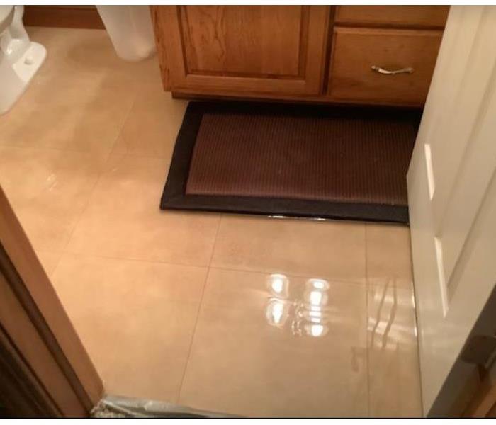 flooded bathroom floor in residential home