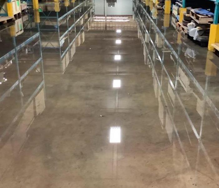 water on concrete floor of warehouse