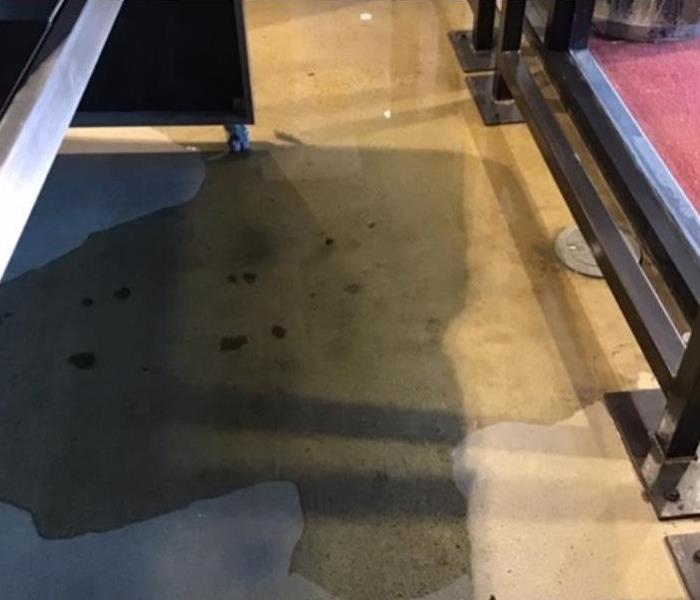 water on concrete floor of commercial building